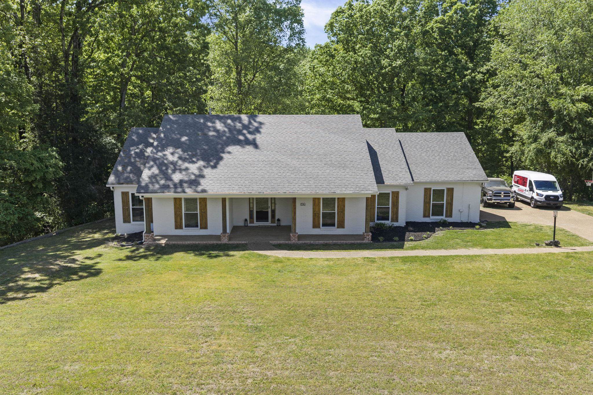 650 Firetower Road Somerville, TN 38068 - Photo 33 of 39 View of front of house featuring a shingled roof, covered porch, and a front yard