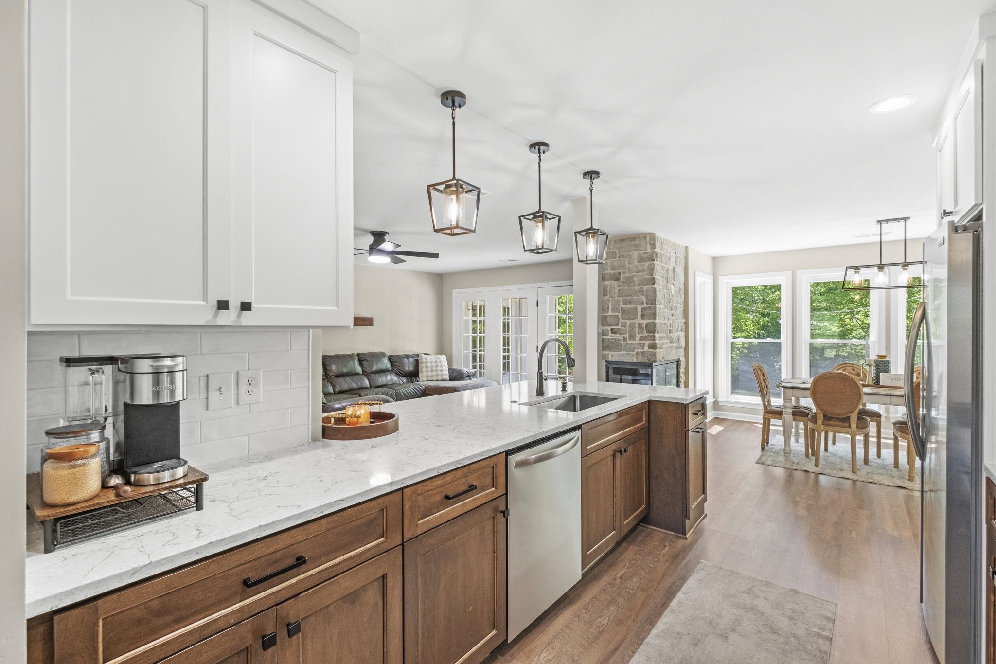 650 Firetower Road Somerville, TN 38068 - Photo 39 of 39 Kitchen with open floor plan, a ceiling fan, dark wood finished floors, light stone counters, and stainless steel appliances