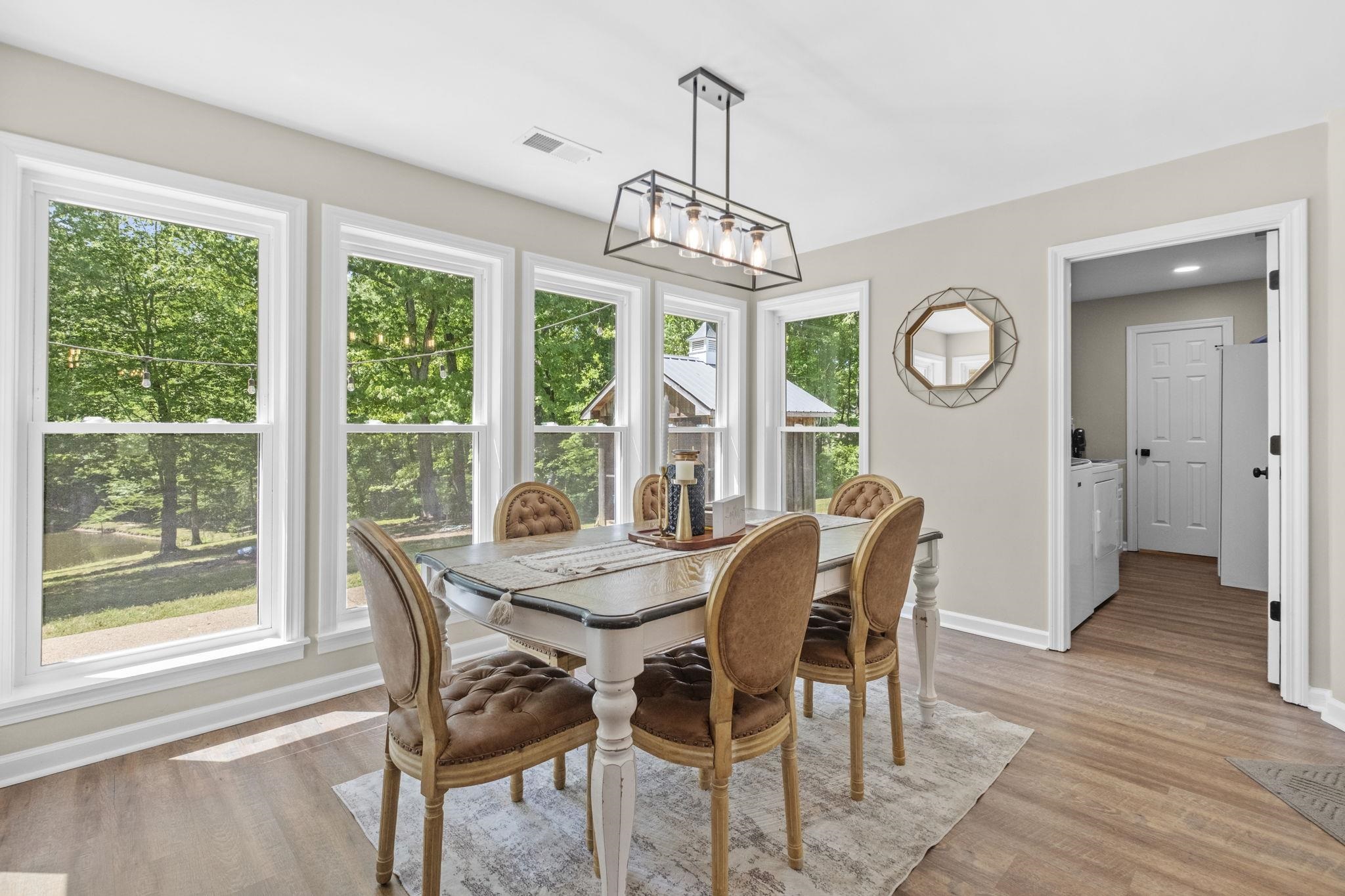 650 Firetower Road Somerville, TN 38068 - Photo 7 of 39 Dining area with light wood-style floors, a chandelier, and washer and clothes dryer
