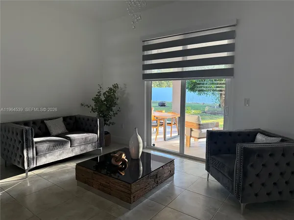 a living room with furniture and a large window