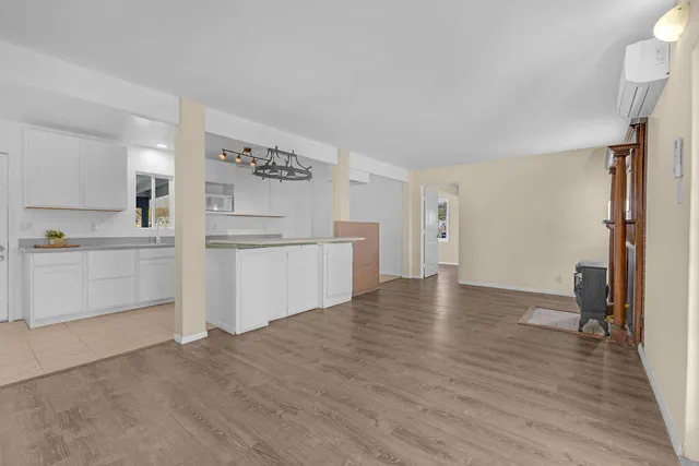 a kitchen with stainless steel appliances granite countertop a sink a stove and a wooden floors