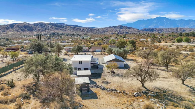 an aerial view of residential house and sandy dunes