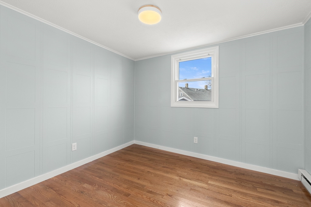 141 Prospect Street Gloucester, MA 01930 - Photo 13 of 32 wooden floor in an empty room with a window