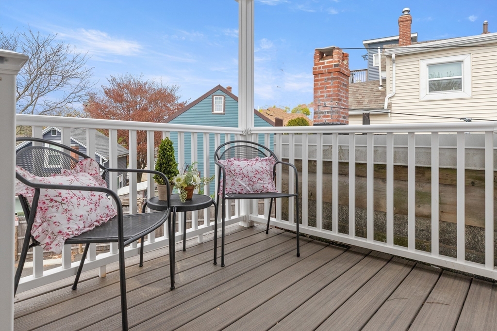 141 Prospect Street Gloucester, MA 01930 - Photo 14 of 32 a view of a balcony with wooden floor and outdoor seating