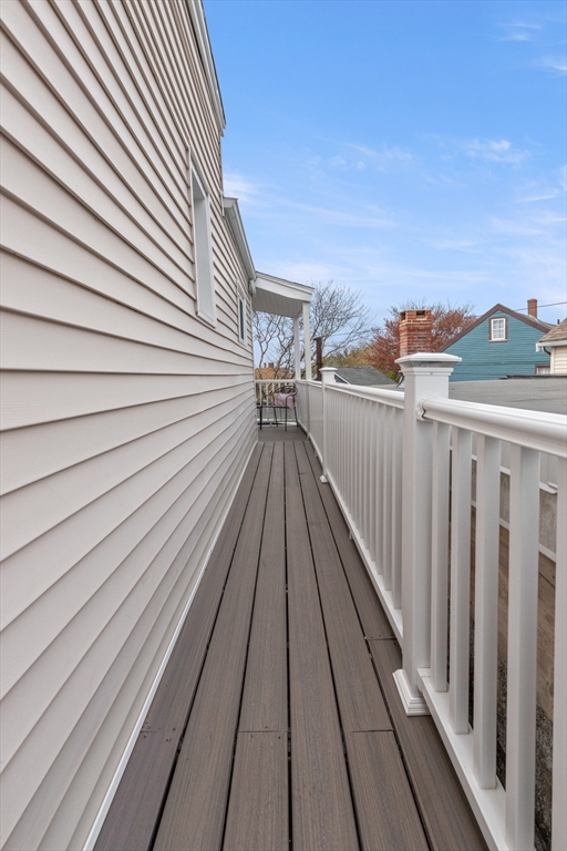 141 Prospect Street Gloucester, MA 01930 - Photo 15 of 32 a view of balcony with wooden floor and fence