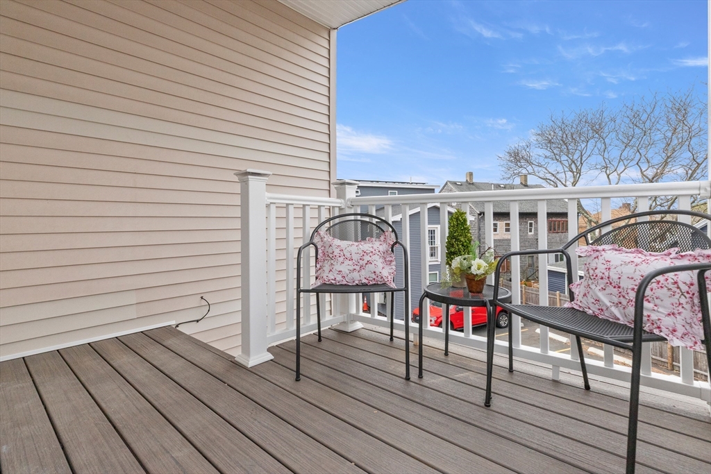 141 Prospect Street Gloucester, MA 01930 - Photo 2 of 32 a view of a deck with chairs and wooden floor
