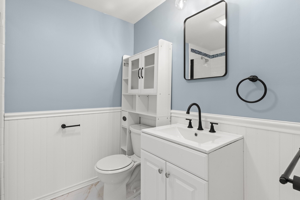 141 Prospect Street Gloucester, MA 01930 - Photo 21 of 32 a bathroom with a toilet sink and mirror