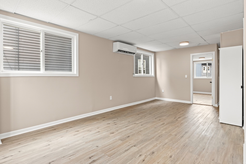 141 Prospect Street Gloucester, MA 01930 - Photo 23 of 32 a view of an empty room with wooden floor and a window