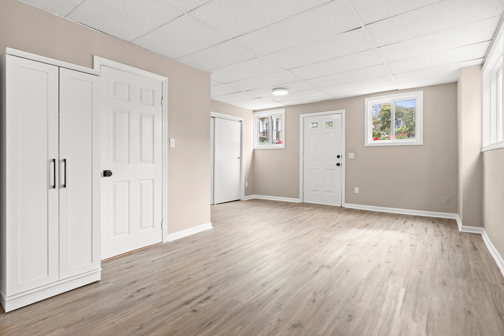 141 Prospect Street Gloucester, MA 01930 - Photo 25 of 32 an empty room with wooden floor and windows