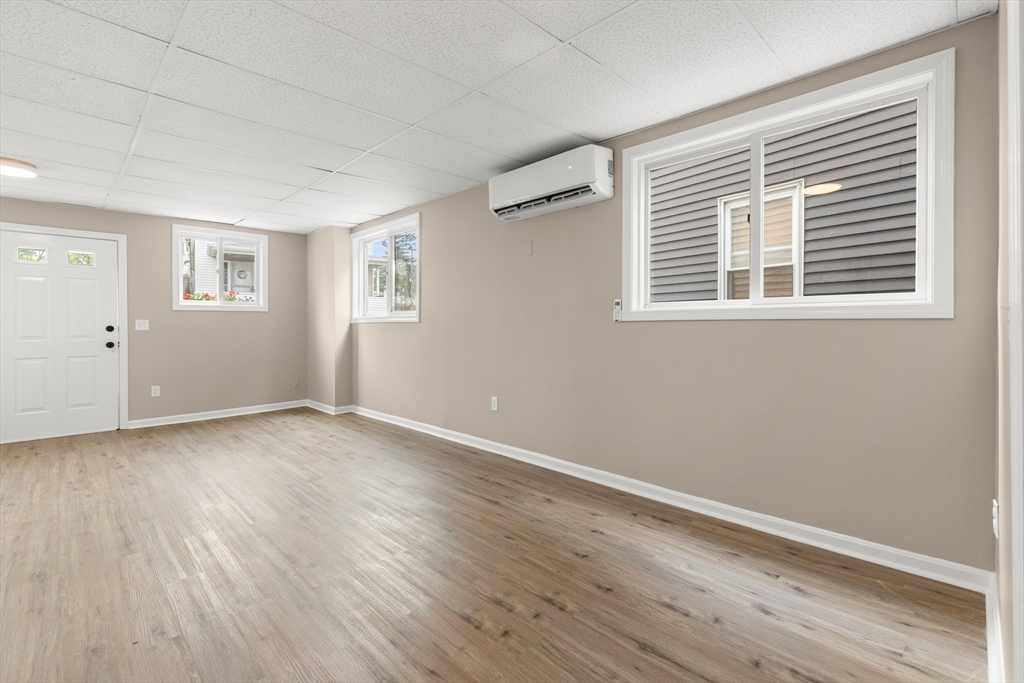 141 Prospect Street Gloucester, MA 01930 - Photo 27 of 32 a view of an empty room with wooden floor and a window
