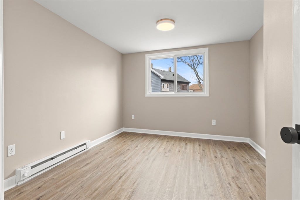 141 Prospect Street Gloucester, MA 01930 - Photo 28 of 32 an empty room with wooden floor and window
