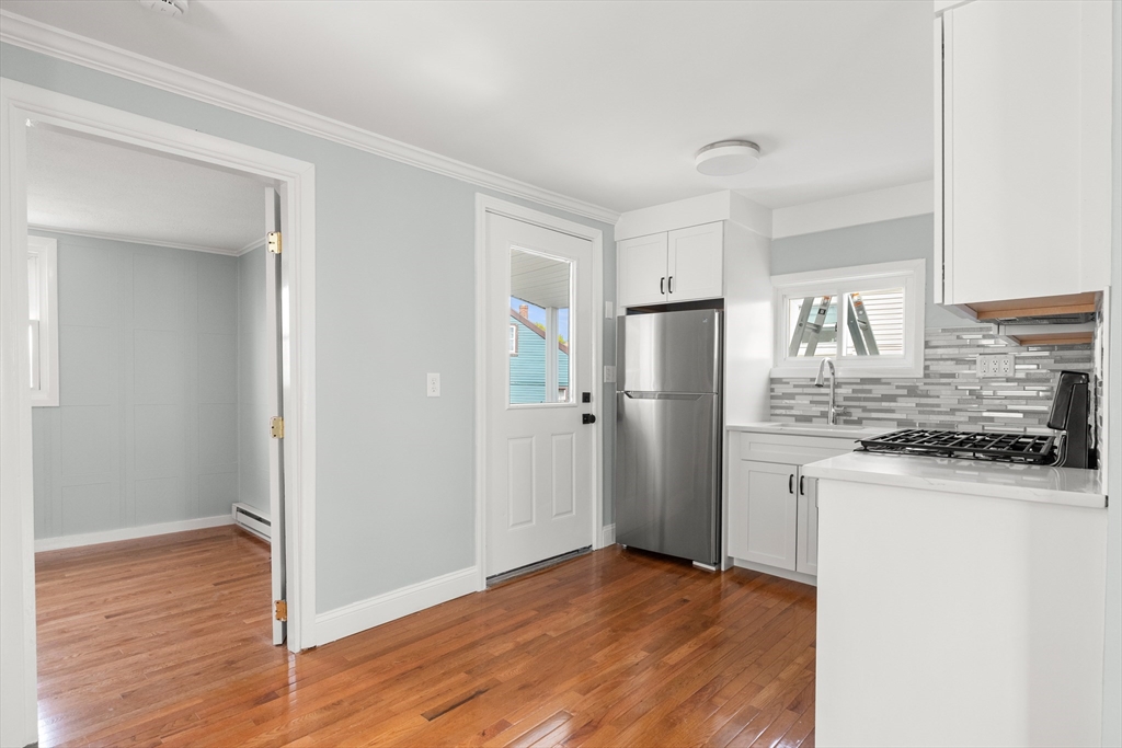 141 Prospect Street Gloucester, MA 01930 - Photo 4 of 32 a kitchen with stainless steel appliances granite countertop a refrigerator and a sink
