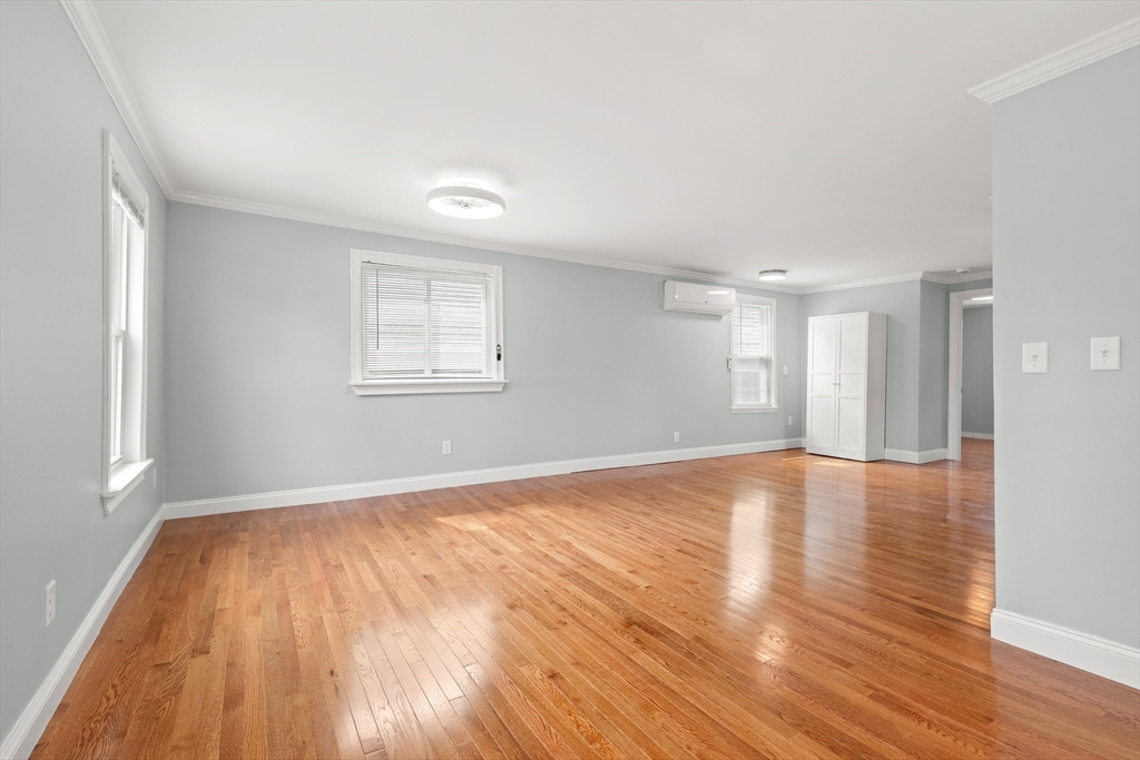 141 Prospect Street Gloucester, MA 01930 - Photo 6 of 32 an empty room with wooden floor and windows