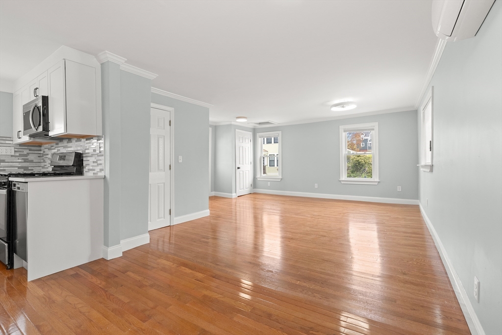 141 Prospect Street Gloucester, MA 01930 - Photo 8 of 32 a view of empty room with wooden floor and fan