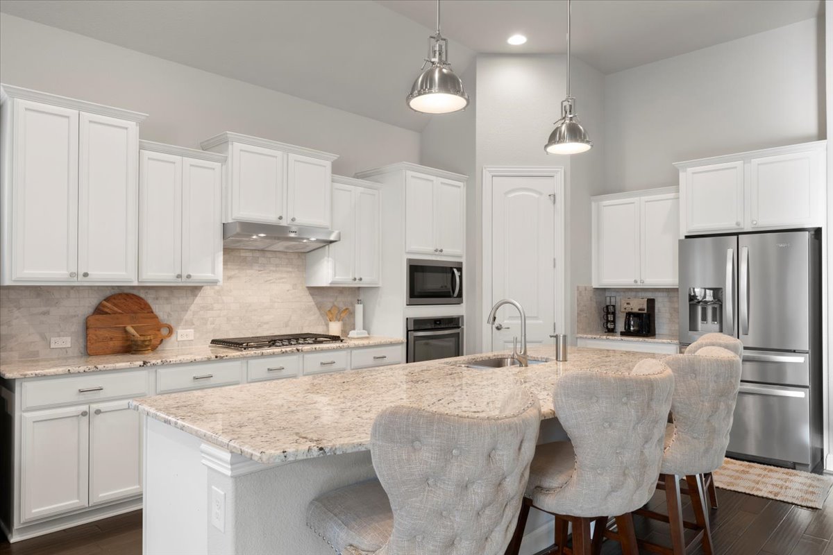 837 Bliss Lane Leander, TX 78641 - Photo 4 of 37 The gourmet kitchen features a large center island with convenient breakfast bar seating.