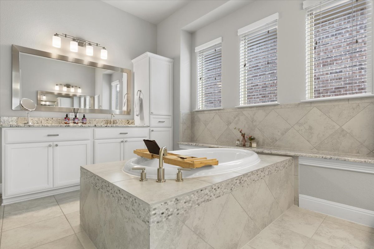 837 Bliss Lane Leander, TX 78641 - Photo 7 of 37 A relaxing soaking tub creates a spa-like atmosphere in the primary bathroom.