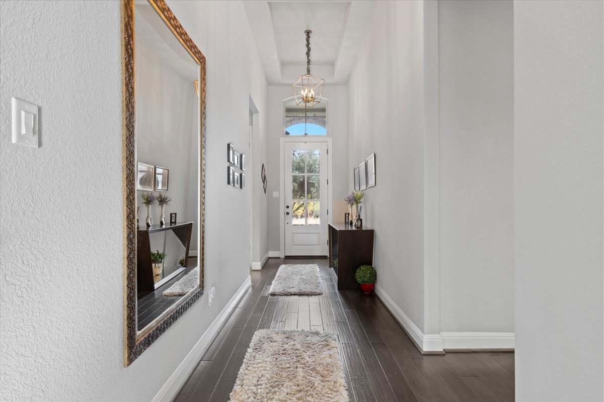 837 Bliss Lane Leander, TX 78641 - Photo 9 of 37 Rich hardwood flooring and soaring ceilings greet you in the main entryway.