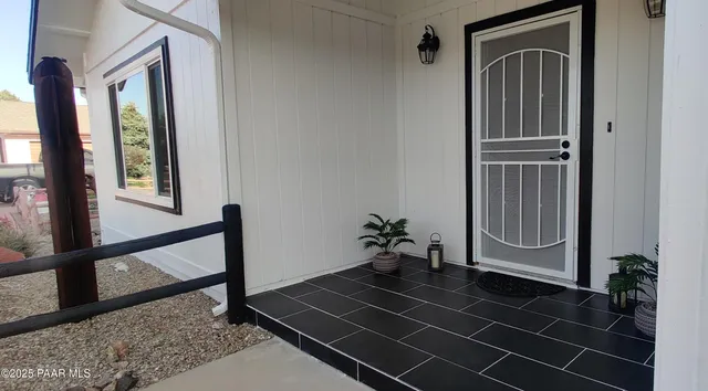 a living room with furniture a window and a fireplace