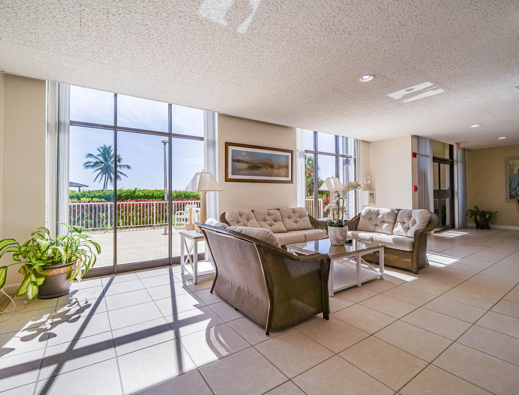 3200 North Hwy A1A, Unit 307 Hutchinson Island, FL 34949 - Photo 12 of 47 a living room with furniture a dining table and a potted plant