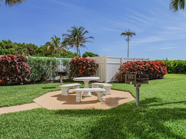 a view of a table and chairs in patio with a tree