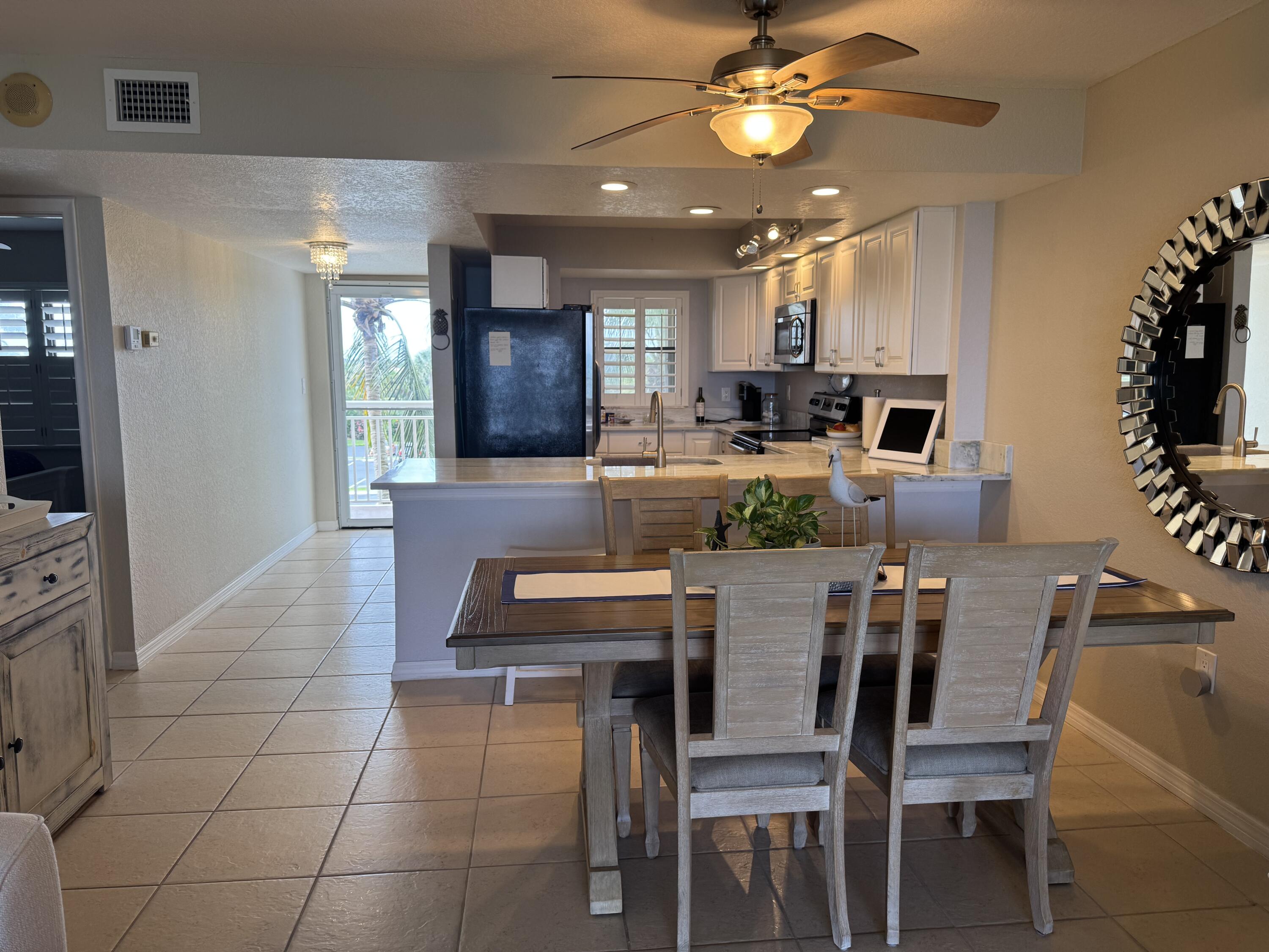 3200 North Hwy A1A, Unit 307 Hutchinson Island, FL 34949 - Photo 29 of 47 a view of a dining room with furniture