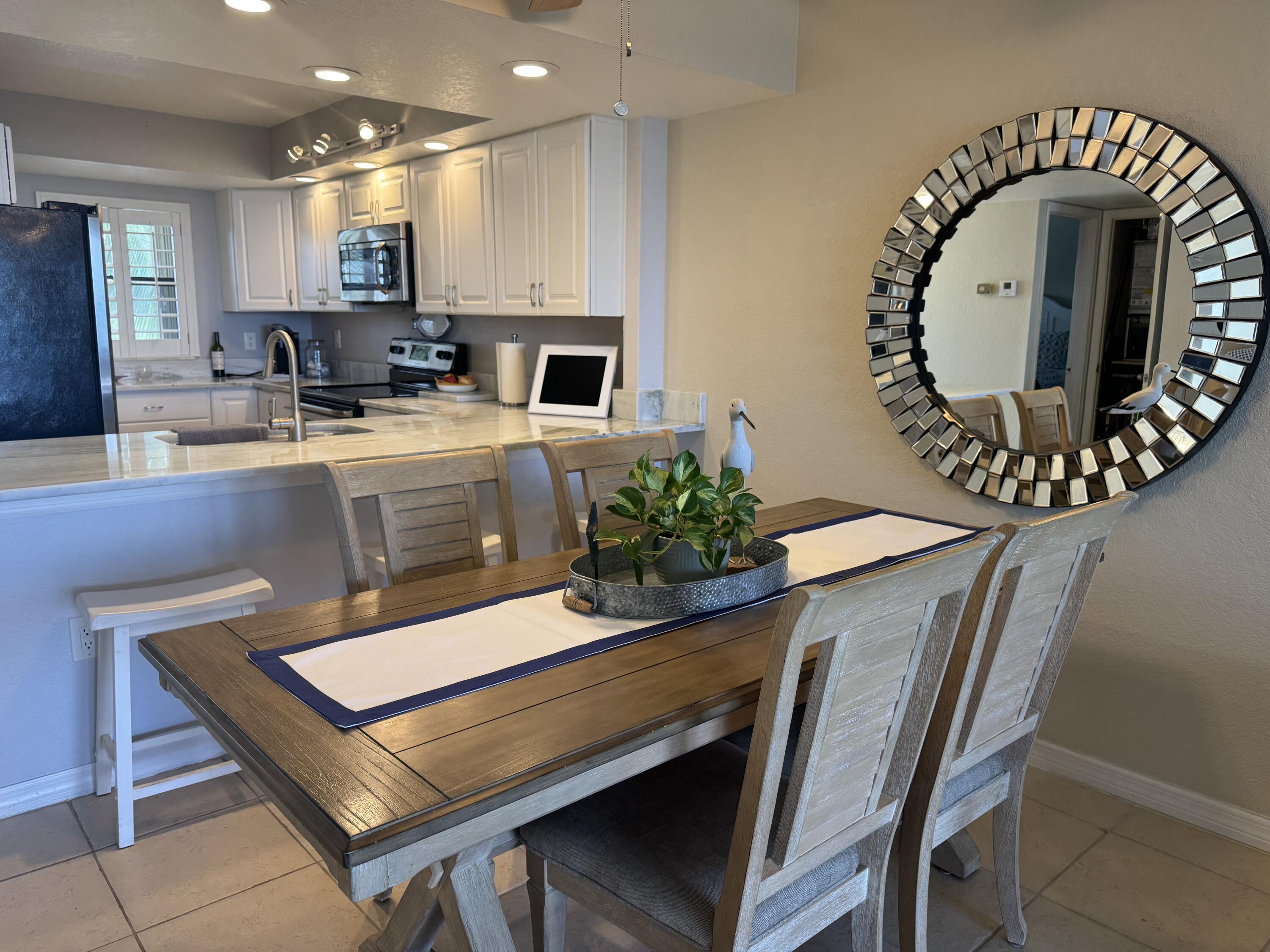 3200 North Hwy A1A, Unit 307 Hutchinson Island, FL 34949 - Photo 30 of 47 a view of kitchen with kitchen island a stove and a wooden floor