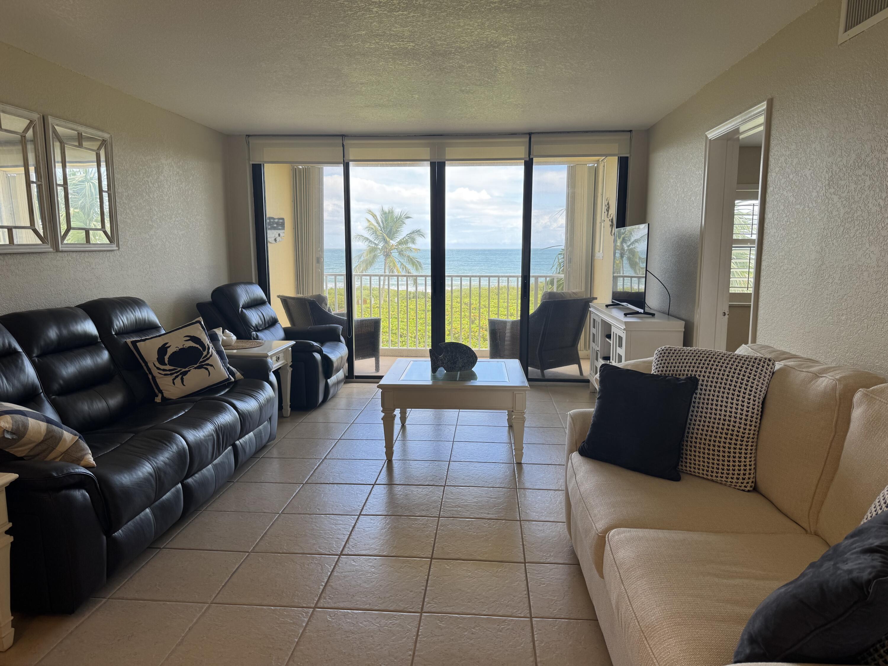 3200 North Hwy A1A, Unit 307 Hutchinson Island, FL 34949 - Photo 31 of 47 a living room with furniture and a large window