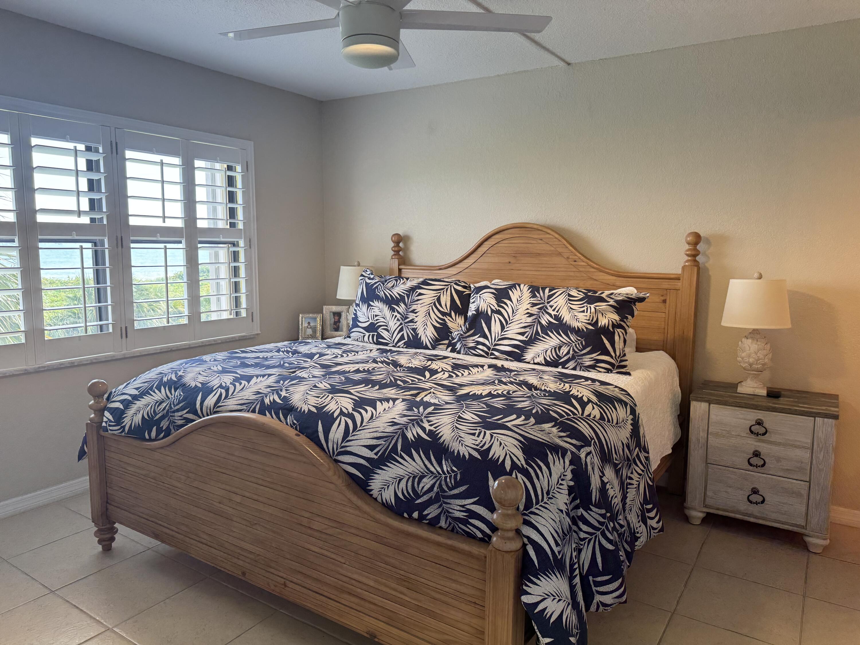 3200 North Hwy A1A, Unit 307 Hutchinson Island, FL 34949 - Photo 32 of 47 a bed sitting in a bedroom next to a window