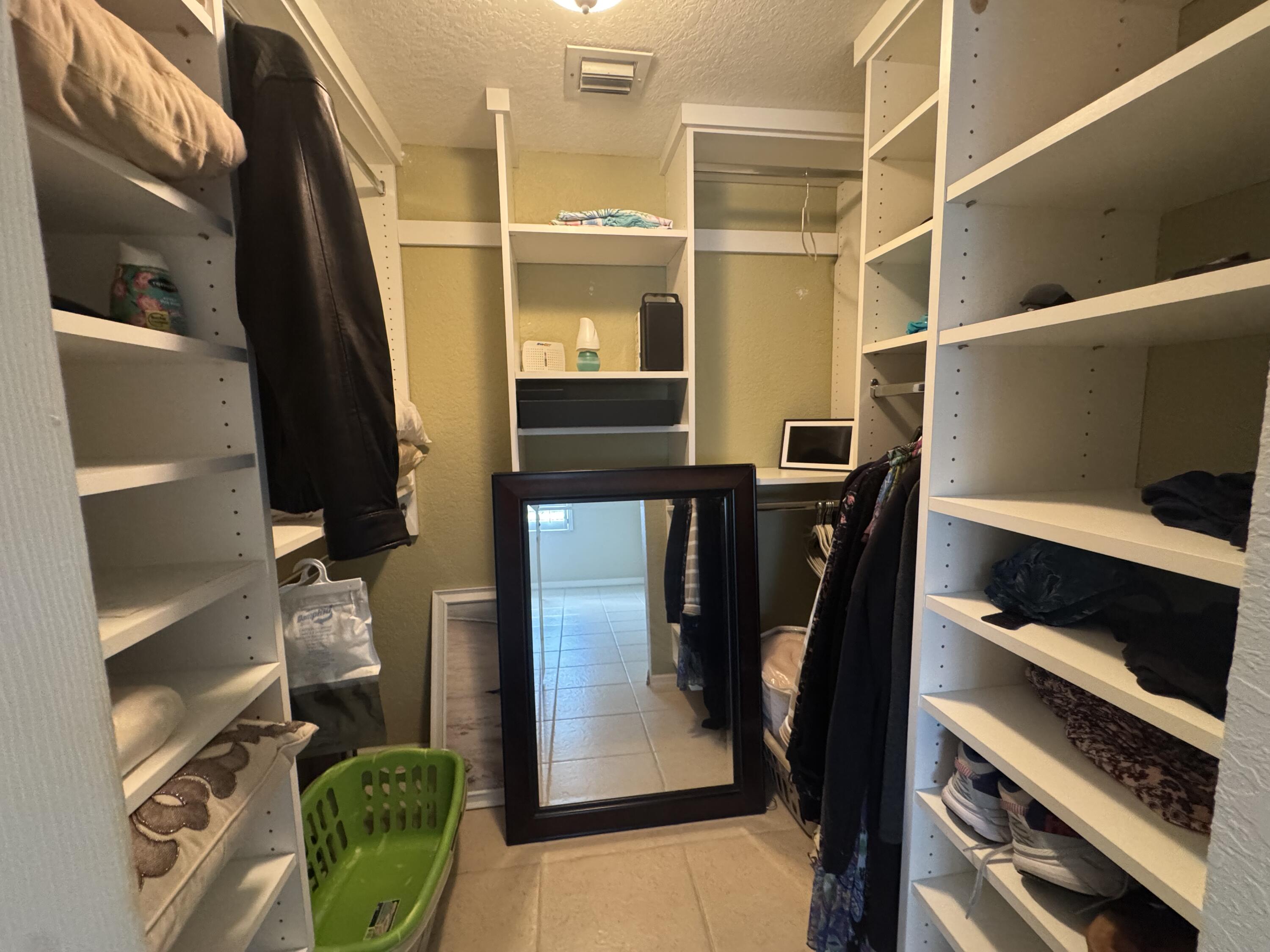 3200 North Hwy A1A, Unit 307 Hutchinson Island, FL 34949 - Photo 34 of 47 a view of walk in closet with clothes and shoes