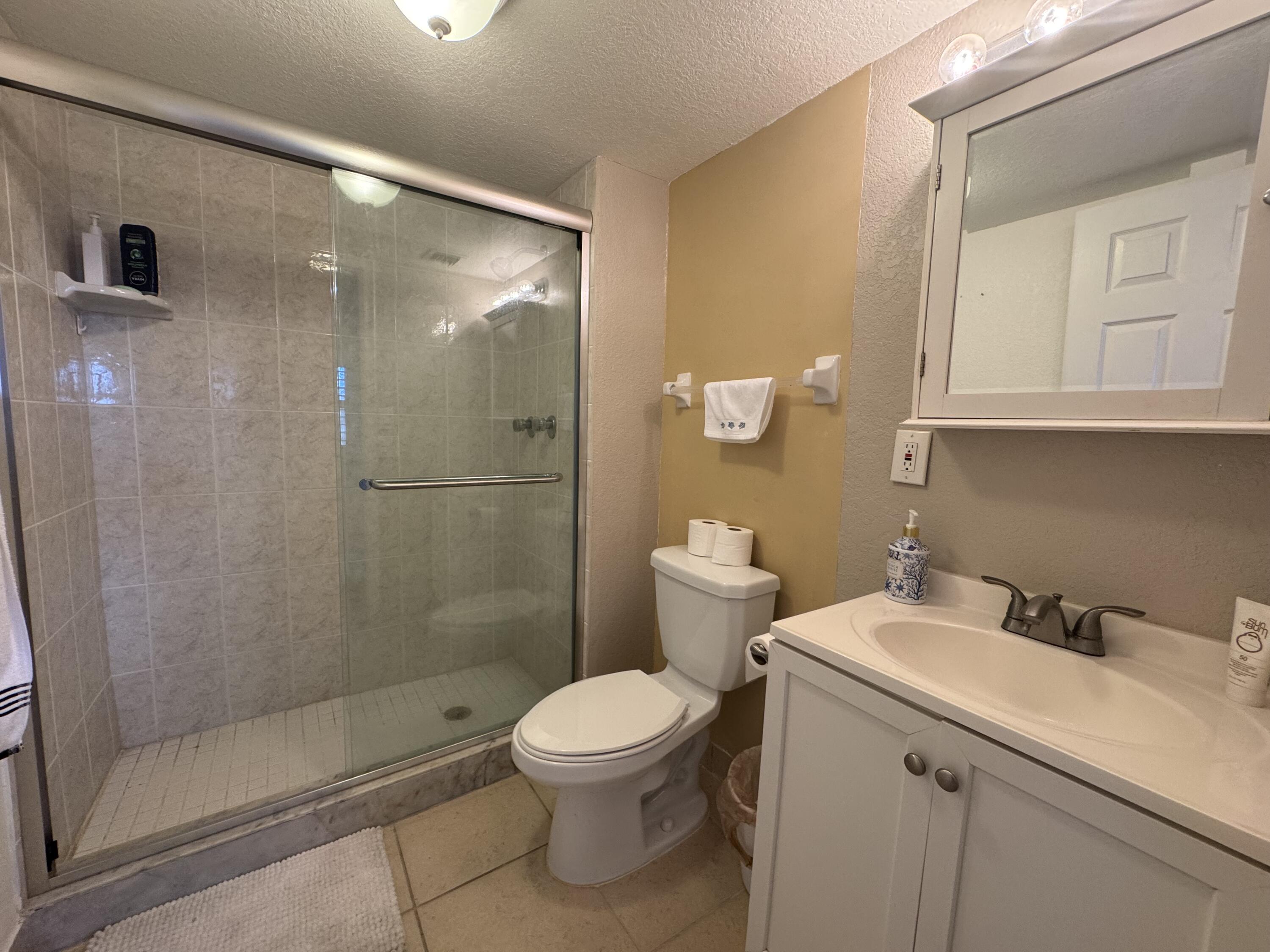 3200 North Hwy A1A, Unit 307 Hutchinson Island, FL 34949 - Photo 44 of 47 a bathroom with a toilet sink and shower