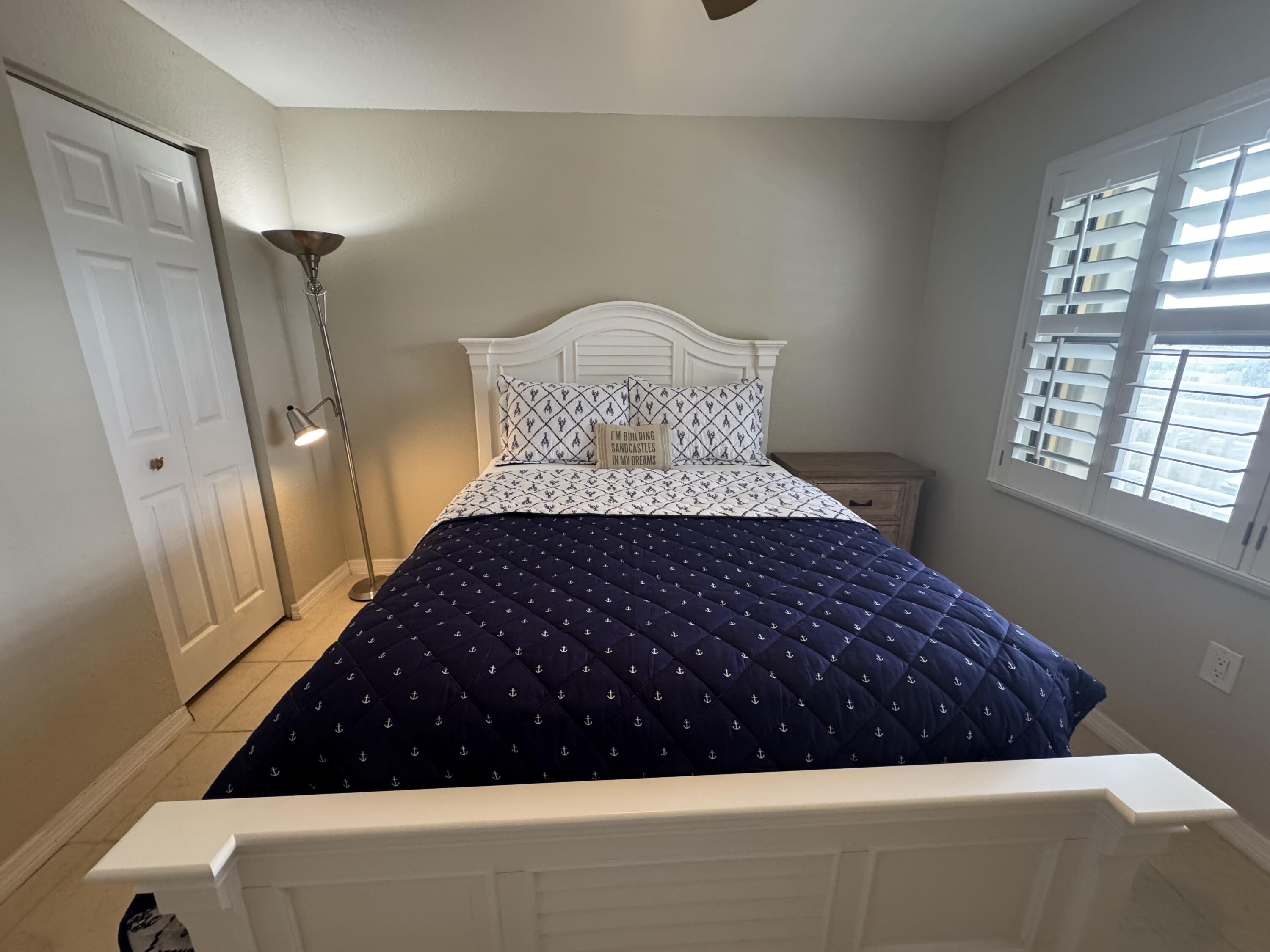 3200 North Hwy A1A, Unit 307 Hutchinson Island, FL 34949 - Photo 45 of 47 a bedroom with a bed and a window