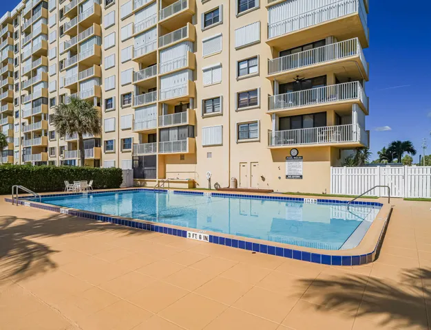 a view of a swimming pool with a lounge chair