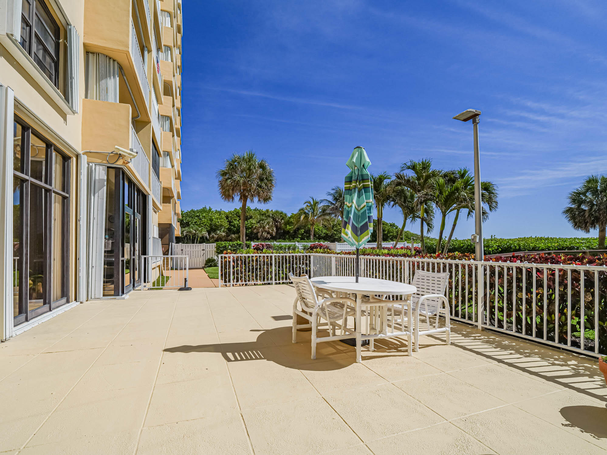 3200 North Hwy A1A, Unit 307 Hutchinson Island, FL 34949 - Photo 8 of 47 a view of a patio with couches chairs and potted plants