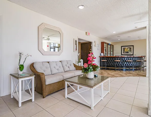 a living room with furniture and flowers