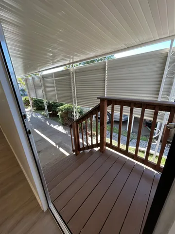 a view of balcony with wooden floor