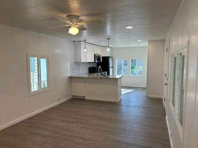a view of kitchen with stove and cabinets
