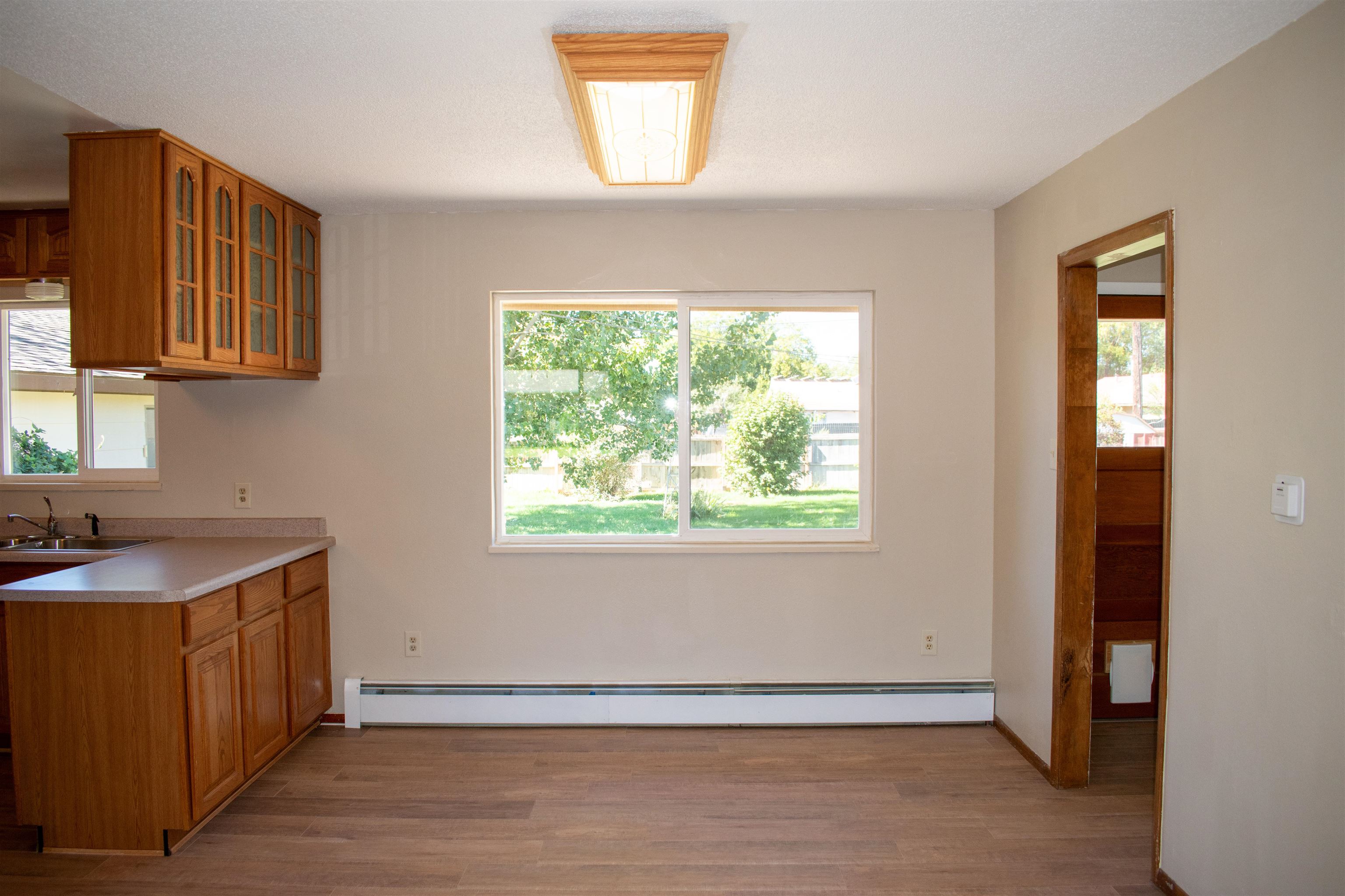 519-29 29 1/4 Road Grand Junction, CO 81504 - Photo 5 of 20 a view of an empty room with wooden floor and a window