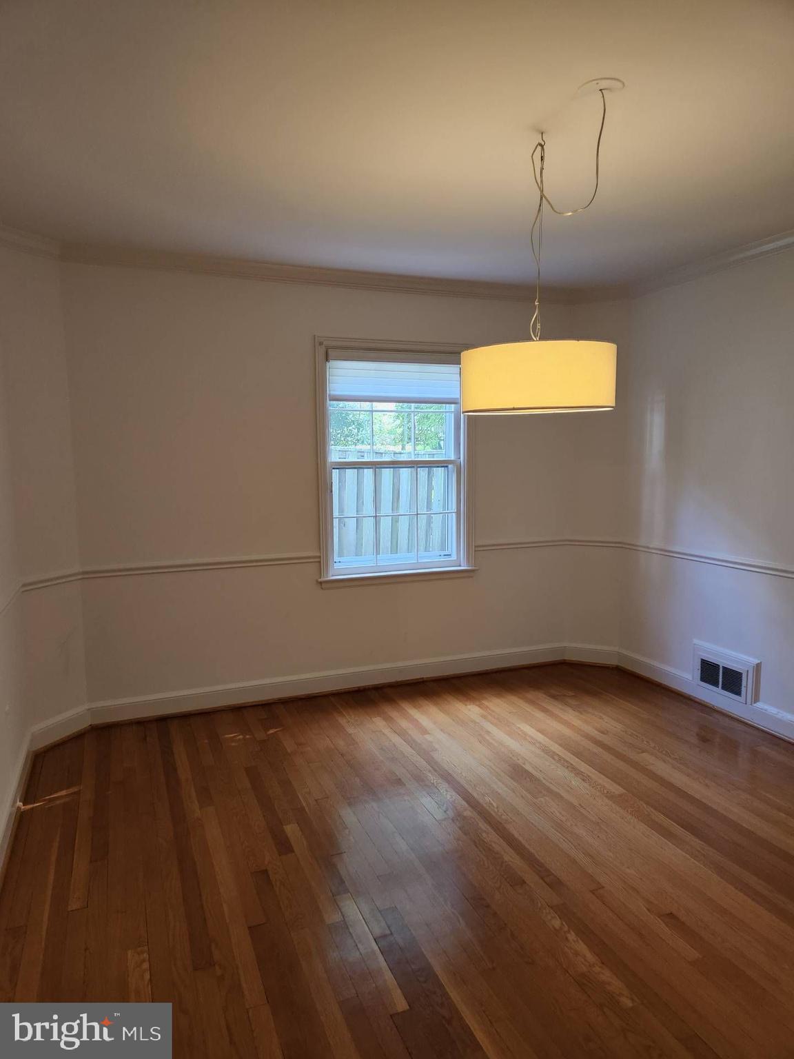 3916 48th Street Northwest Washington, DC 20016 - Photo 11 of 29 an empty room with wooden floor and windows