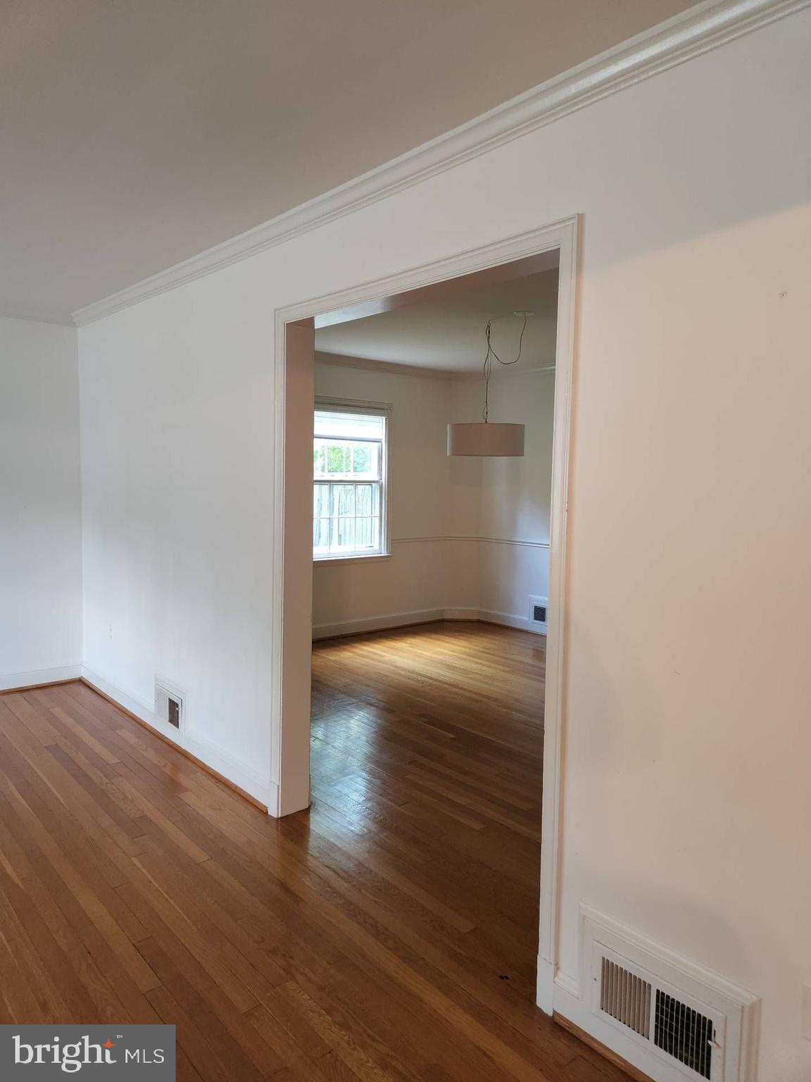 3916 48th Street Northwest Washington, DC 20016 - Photo 13 of 29 a view of an empty room with wooden floor and a window