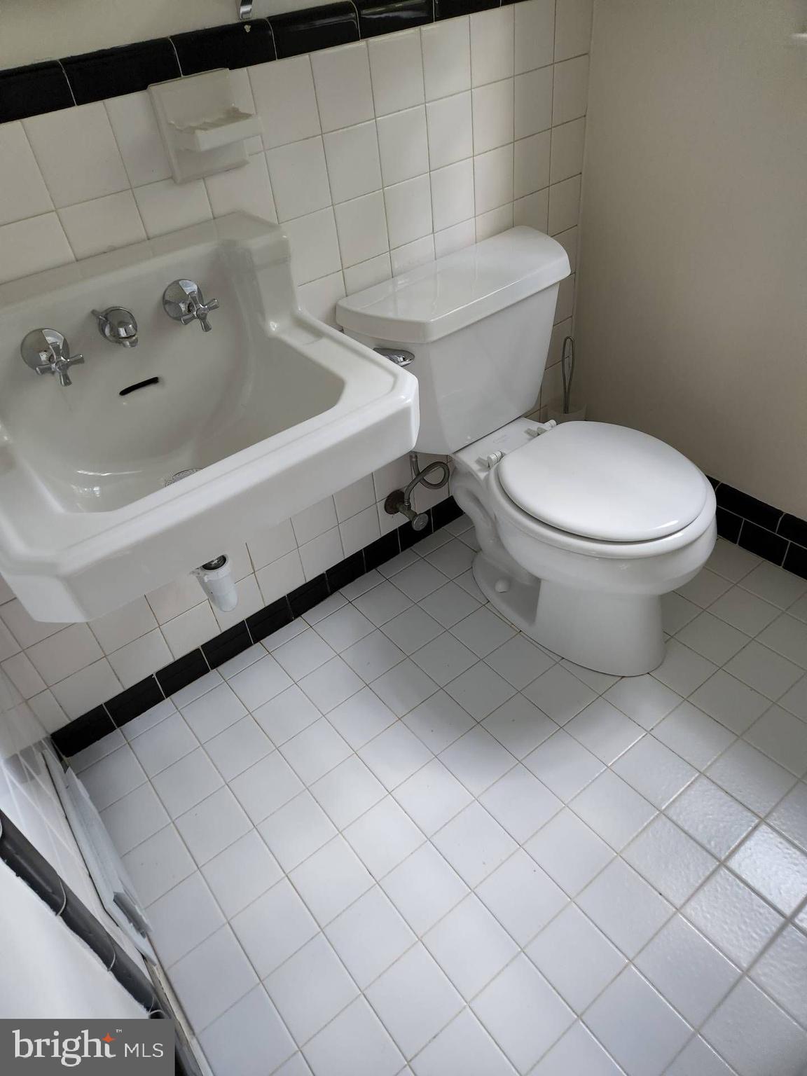 3916 48th Street Northwest Washington, DC 20016 - Photo 18 of 29 a white toilet sitting next to a bathroom sink