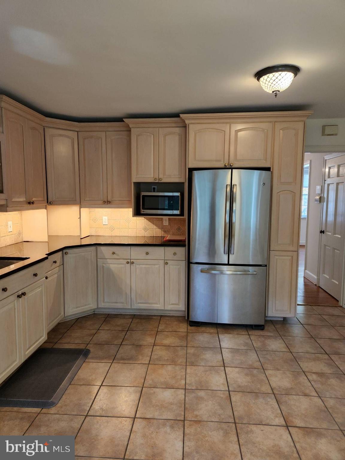 3916 48th Street Northwest Washington, DC 20016 - Photo 2 of 29 a kitchen with stainless steel appliances granite countertop a refrigerator sink and stove
