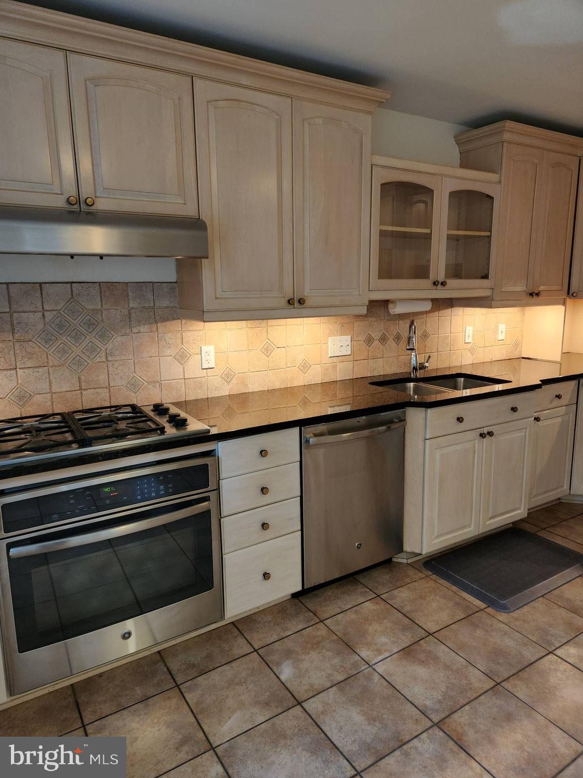 3916 48th Street Northwest Washington, DC 20016 - Photo 3 of 29 a kitchen with granite countertop a sink and cabinets