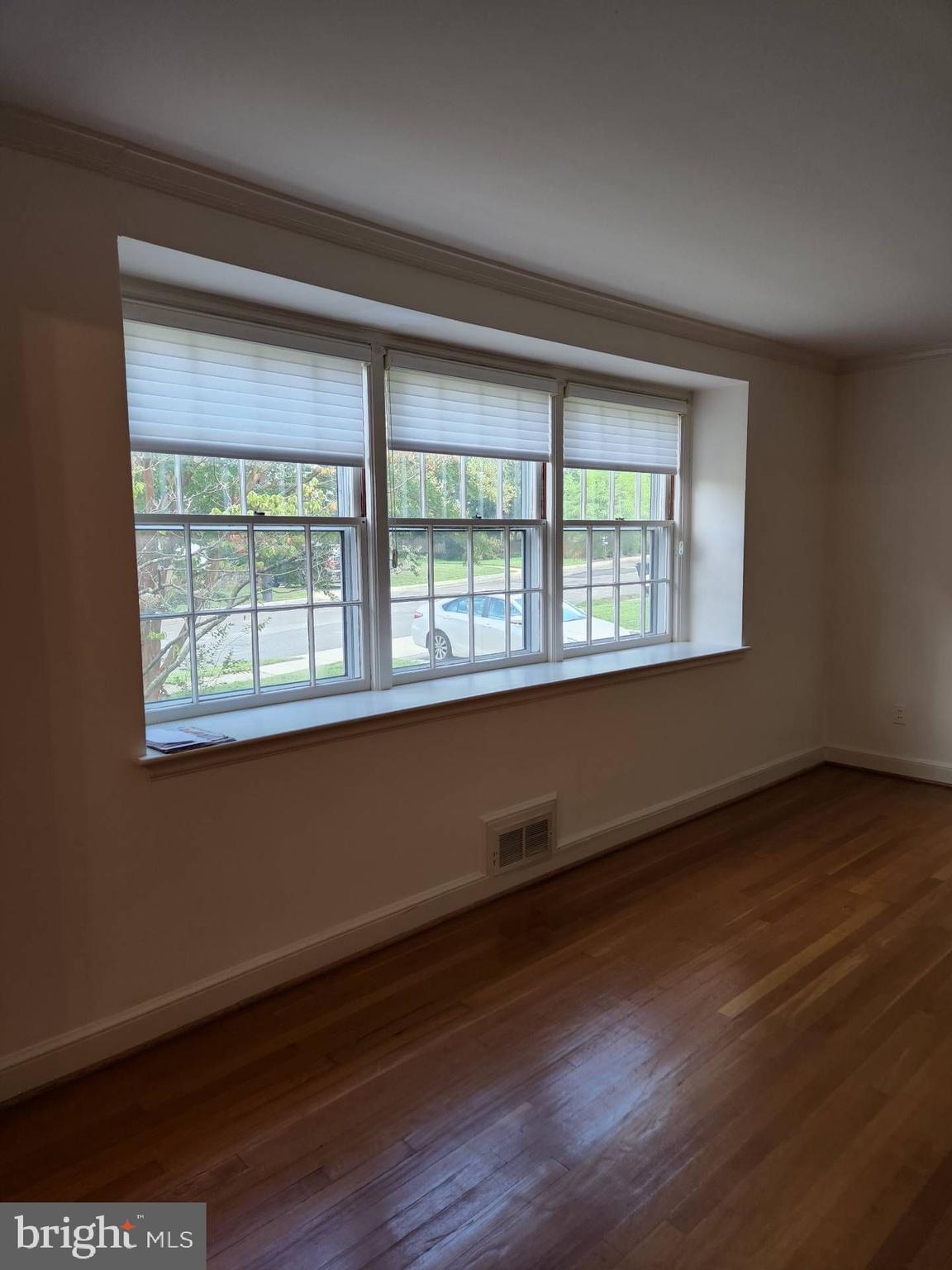 3916 48th Street Northwest Washington, DC 20016 - Photo 8 of 29 a view of an empty room with wooden floor and a window