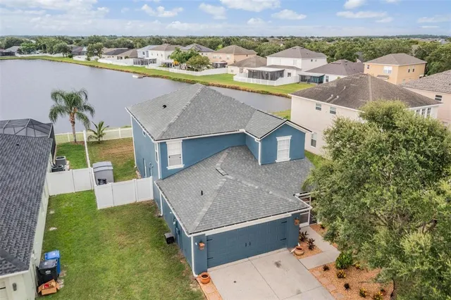an aerial view of residential houses with outdoor space and parking