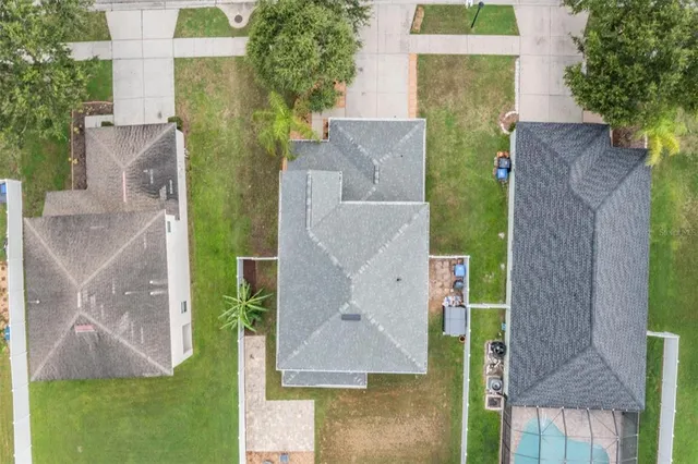 aerial view of a house with a yard and a fountain