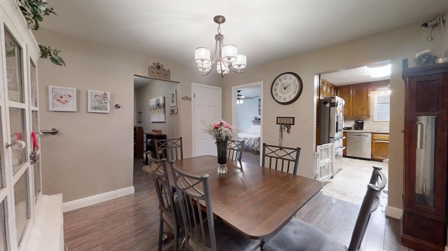 2956 Treen Court Rancho Cordova, CA 95670 - Photo 12 of 67 a view of a dining room with furniture a chandelier and wooden floor