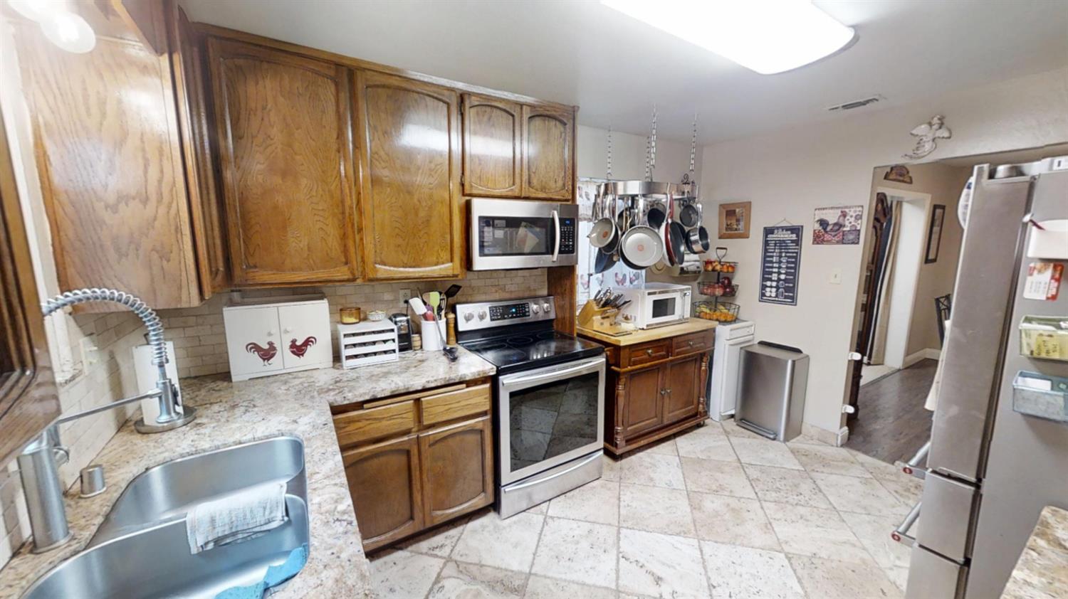 2956 Treen Court Rancho Cordova, CA 95670 - Photo 17 of 67 a kitchen with a sink refrigerator and microwave