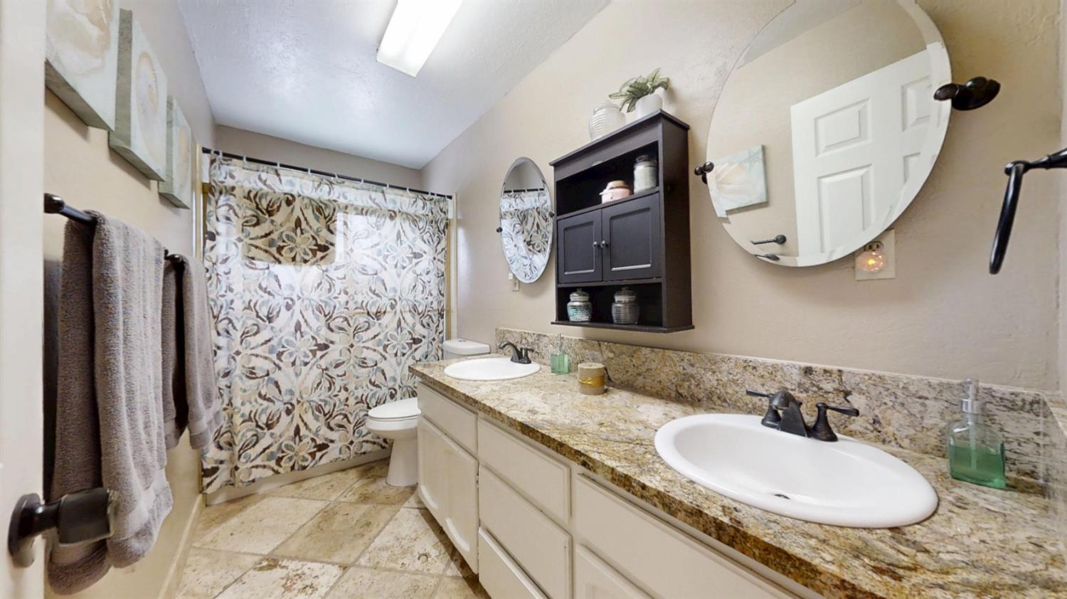 2956 Treen Court Rancho Cordova, CA 95670 - Photo 26 of 67 a bathroom with a granite countertop sink and a mirror