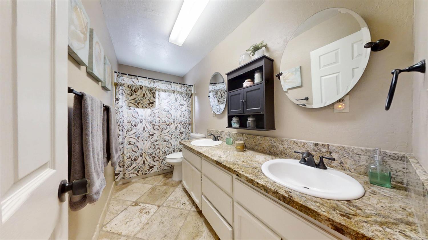 2956 Treen Court Rancho Cordova, CA 95670 - Photo 27 of 67 a bathroom with a granite countertop sink and a mirror