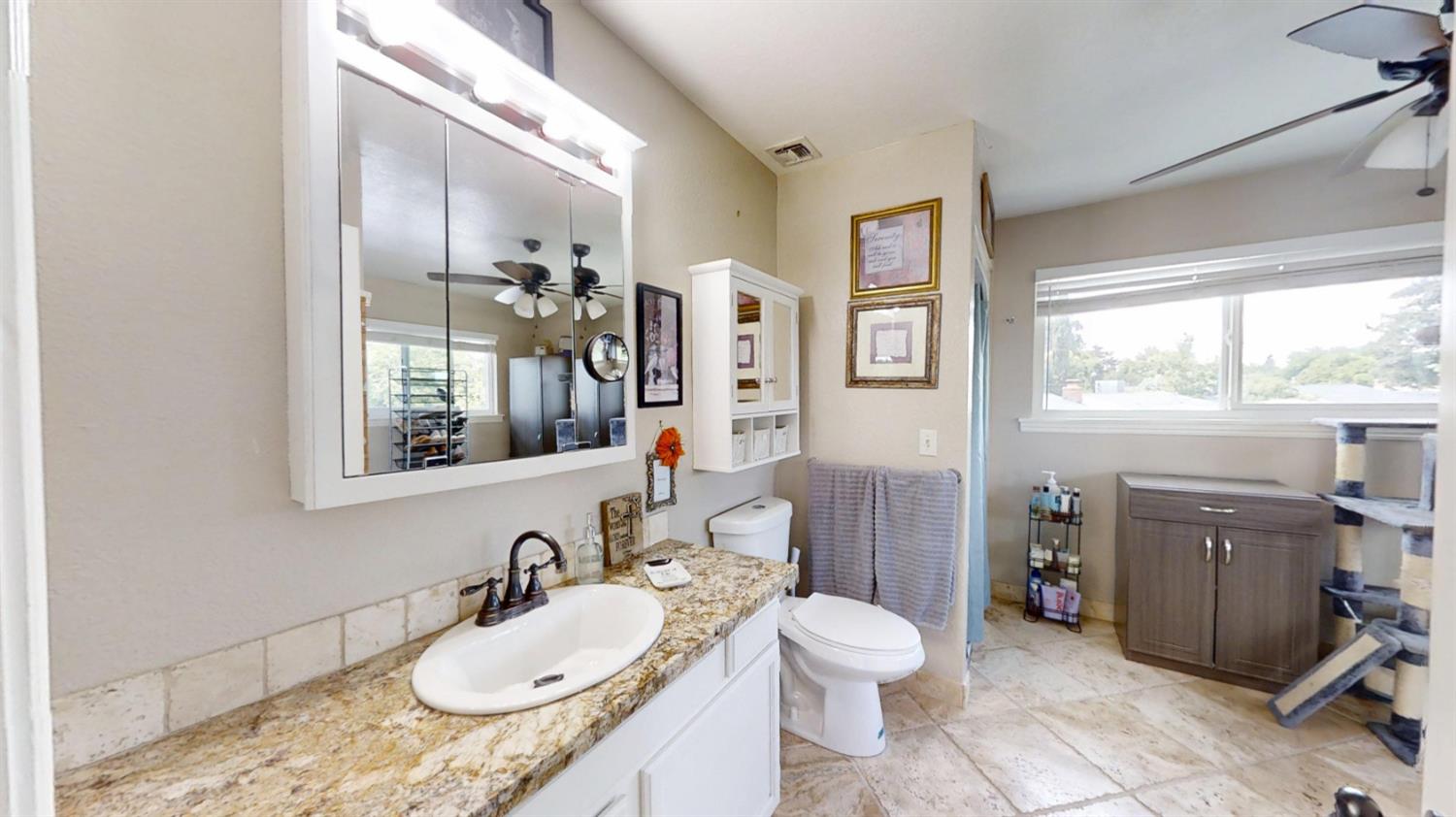 2956 Treen Court Rancho Cordova, CA 95670 - Photo 34 of 67 a bathroom with a granite countertop sink mirror vanity and toilet